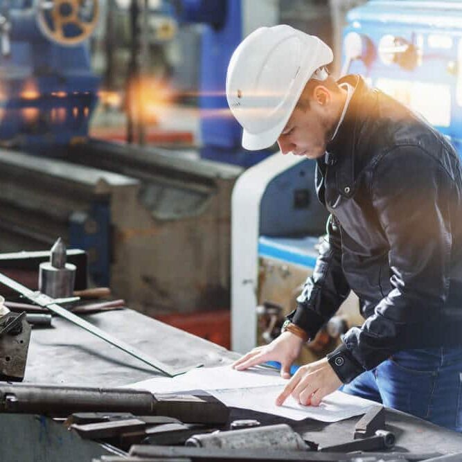 engineer makes a measurement of the details of the mechanism