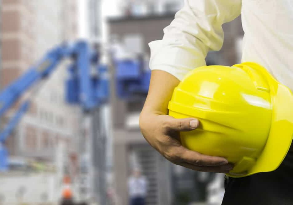 engineer or worker hold in hand yellow helmet