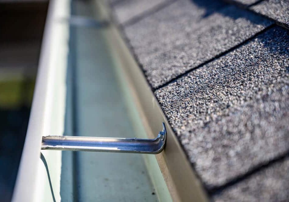 roof gutter with clips and edge of shingles